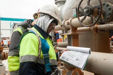 Worker on a construction site looking documents Stock Photos