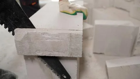 Worker at the construction site. The masonry is built from a lightweight co.. Stock Photos