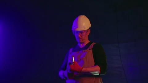 Worker at construction site in neon light Stock Footage 271630989