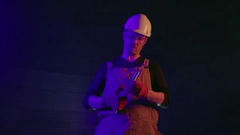 Worker at construction site in neon light Stock Footage 271630994