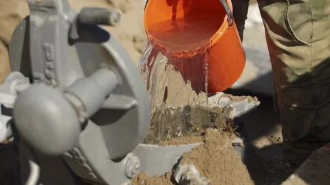 Worker at a construction site pours water with a bucket Stock Footage 269953500