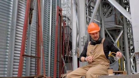 A worker on a construction site rests during a coffee break. Stock Footage 271629911