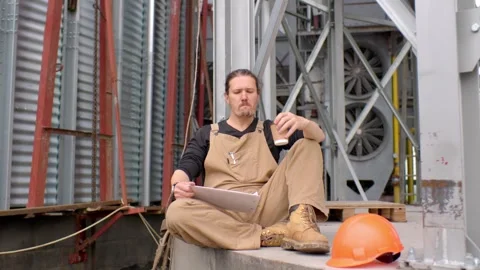 A worker on a construction site rests during a coffee break. Stock Footage 271630071