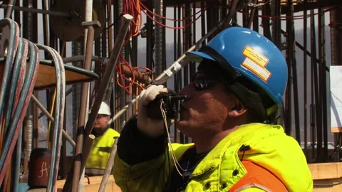 A worker at the construction site talking over the radio. Stock Footage 237308254