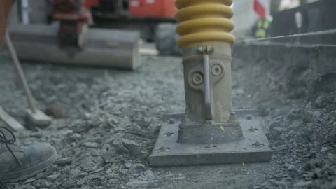 Worker on construction site with vibrating rammer Stock Footage 132696874