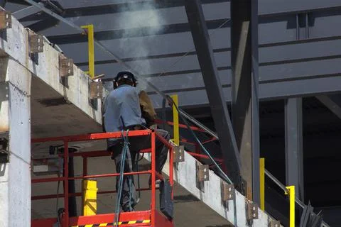 Worker on construction site welding structure concrete building man at work Foto stock