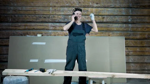 A worker at a construction site where repairs are underway, angrily and with fur Stock Footage 101384393