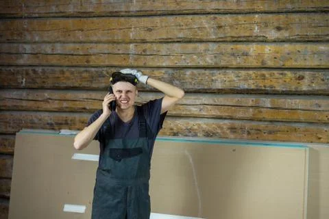 A worker at a construction site where repairs are underway, angrily and with  Stock Photos
