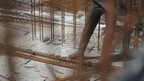 Worker at a construction site works with a large sledgehammer Stock Footage 276668396