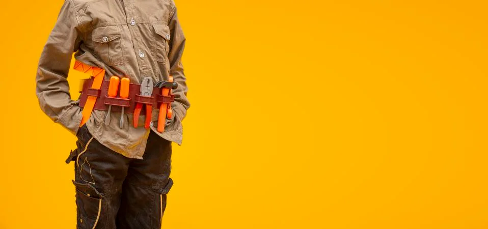 Worker with construction tools on yellow background, labor day concept Foto stock
