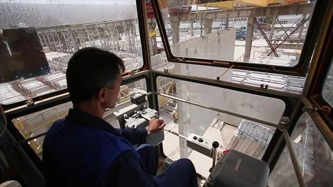 Worker contols the crane. Camera inside the cabin. Stock Footage 70208012