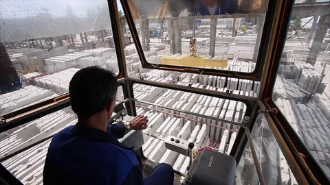 Worker contols the crane. Camera inside the cabin. Stock Footage 70208013