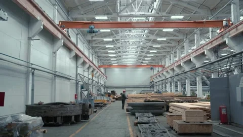 Worker control beam crane Inside industrial factory workshop with stacks of wood Stock Footage 164000475