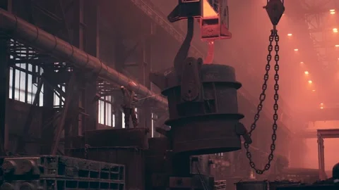 Worker control big container filled with liquid iron for casting mold in Stock Footage 153220406