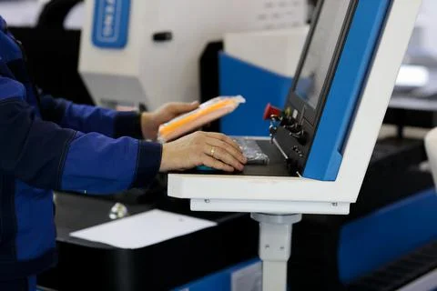 Worker at control console of laser cutting machine Stock Photos