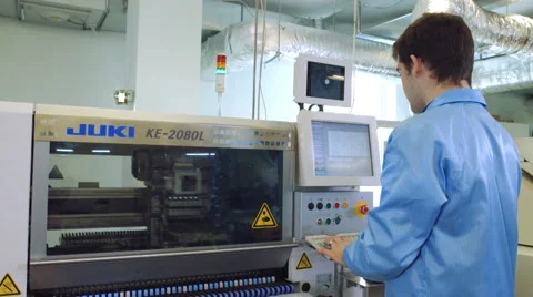 Worker controlling quality of PCB boards Видео 50304413