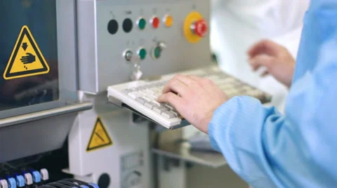Worker controlling quality of PCB boards on production line in factory Stock Footage 50304561