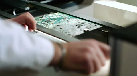 Worker controlling quality of PCB boards on production line in factory Stock Footage 50304766