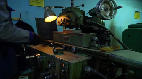 A worker controls and works on a grinding machine. Stock Footage 145867671