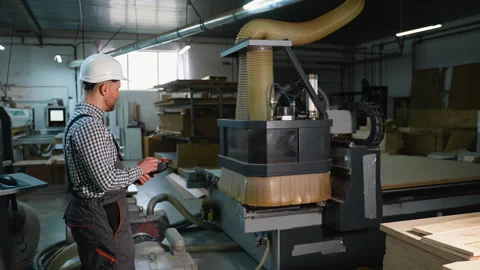 Worker Controls CNC Router Cutting Wooden Panels Video stock 305603218