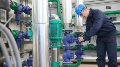 Worker controls devices in a Heating Plant Stock Footage 24651671
