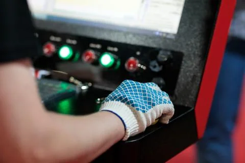 Worker controls modern computerized machine Stock Photos
