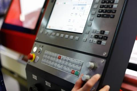 Worker controls the operation of the CNC machine Stock Photos