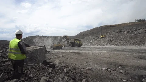 Worker controls the process of coal loading in career Video stock 114829705
