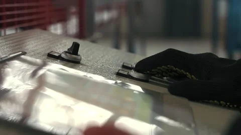 Worker controls remote control metal steel sheet rolling cutting machine Video stock 265413420