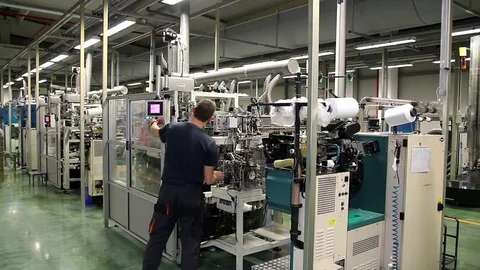 Worker Controls the Work of the Automated Machine Stock Footage 76737501