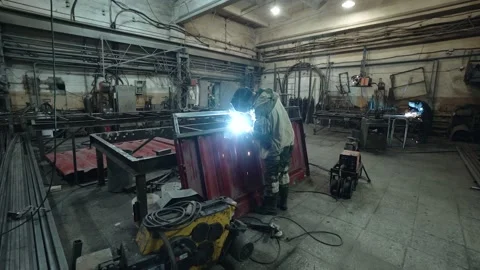 A worker cooks metal on a welding machine in production. a worker with a welding 스톡 동영상 178852506