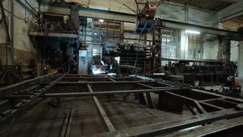 A worker cooks metal on a welding machine in production. a worker with a welding Stock Footage 178852837
