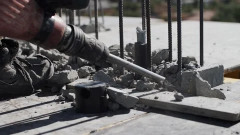 Worker crushes concrete with a jackhammer Stock Footage 134385435