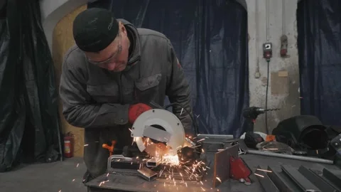 The worker cut the metal with circular saw Stockbeeldmateriaal 225769472