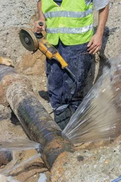 Worker cut section of water main pipe Stock Photos