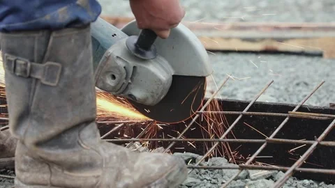 A worker cuts the armature by the circular saw close up Stock Footage 131180142