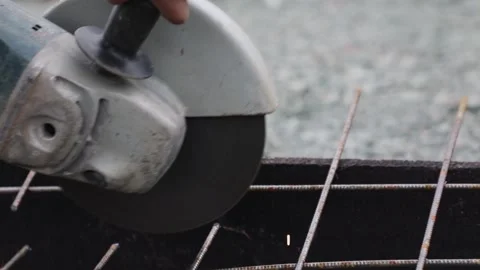 A worker cuts the armature by the circular saw close up Stock Footage 131180148