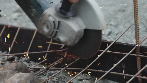 A worker cuts the armature by the circular saw close up Stock Footage 131180149
