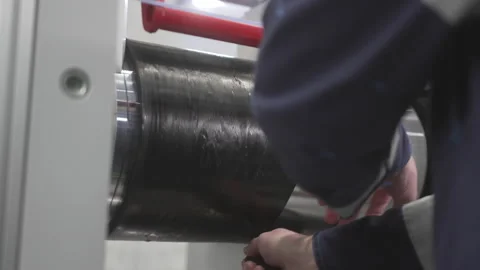 Worker cuts asymmetric rubber sheet from recycled rubber Stock Footage 324071088