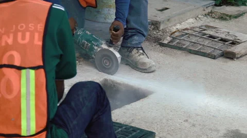 The worker cuts a concrete block with a manual cut off machine. Close up shot Stock Footage 168907696