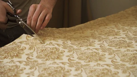 Worker cuts the fabric with scissors Stock Footage 128369889