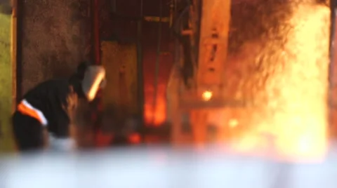 Worker cuts fiery steel blocks Видео 47891705