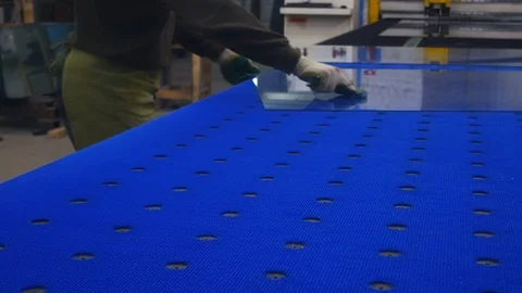 A worker cuts glass on the table.In the hands of the glass cutter.Breaks hands. Stock Footage 122466434