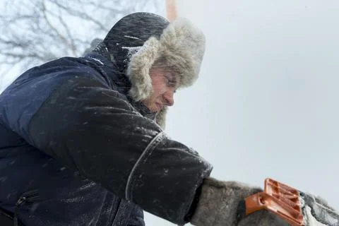 Worker cuts ice panel with gasoline saw 写真素材