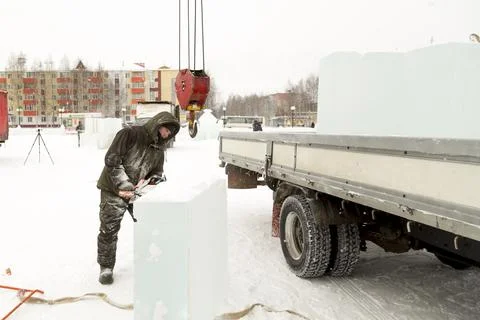 Worker cuts ice panel with gasoline saw 스톡 사진