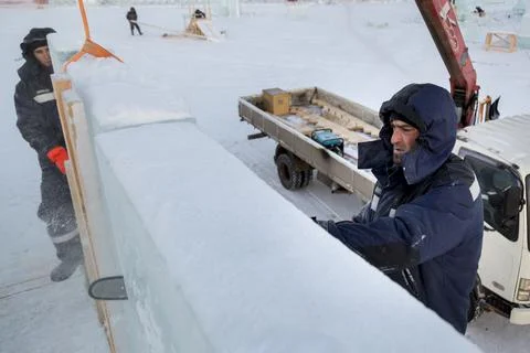 Worker cuts ice panel with gasoline saw 스톡 사진