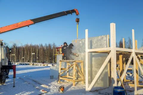 Worker cuts ice panel with gasoline saw 스톡 사진