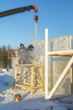 Worker cuts ice panel with gasoline saw 写真素材
