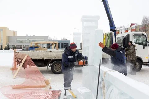 Worker cuts ice panel with gasoline saw 스톡 사진