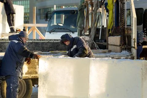 Worker cuts ice panel with gasoline saw 스톡 사진